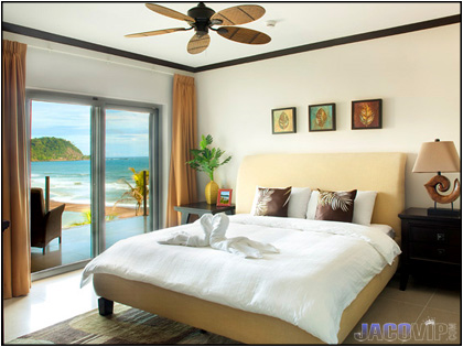 Master bedroom with king size bed and view of beach and ocean
