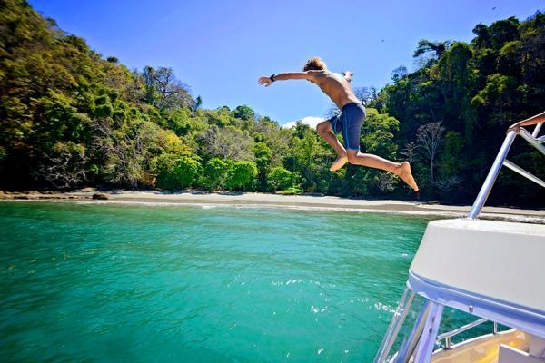 jumping off of catamaran into the ocean