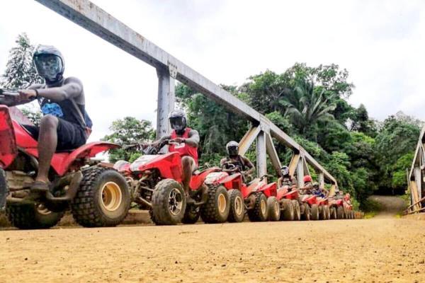 ATVs gathered beside the iron bridge over the Tulín River