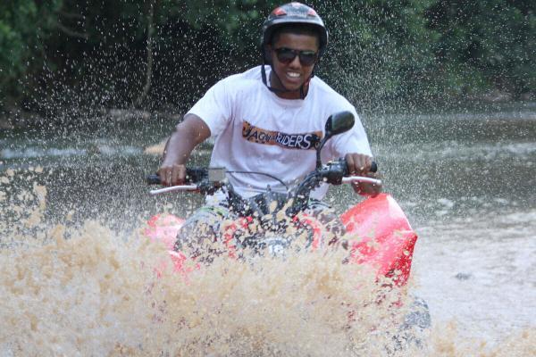ATV rider crossing an approved shallow stretch of river