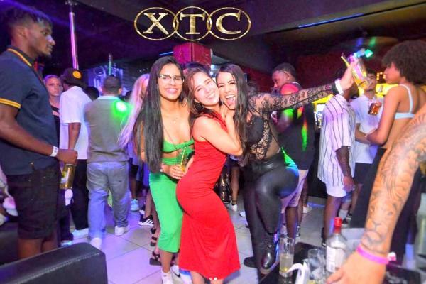 Party crowd dancing to Latin and hip hop beats at XTC Nightclub in Jaco Beach