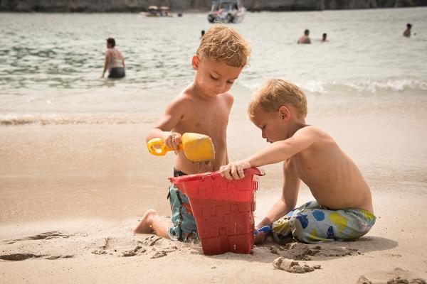 2 brothers playing at the beach