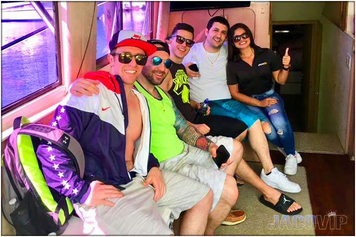 Group of guys with jaco vip concierge in salon of party boat