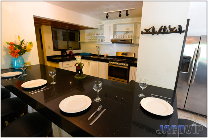 Facing the kitchen with plates on bar