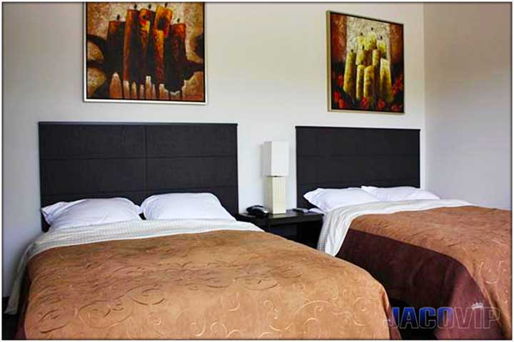 2 queen size beds with artwork on the wall
