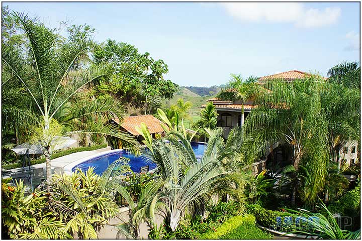 View of pool from window in bathroom