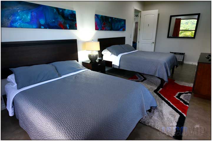 2 large beds with blue paintings