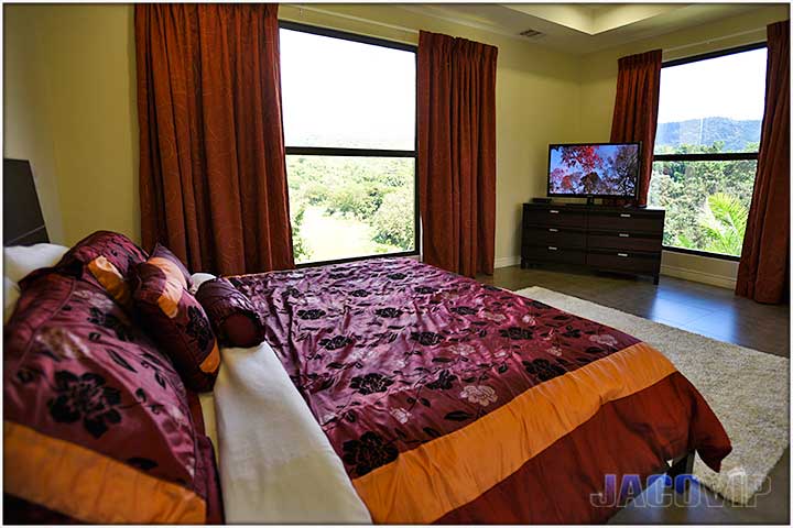 Master bedroom with large tv and mountain views