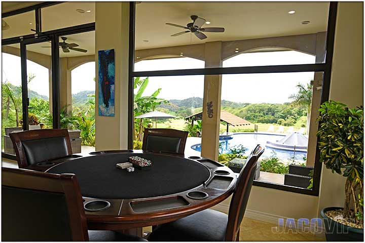 living room poker table with view to swimming pool