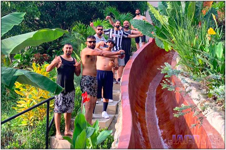 Group of guys next to water slide