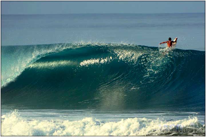 Surfer riding large wave in Hermosa Beach Costa Rica