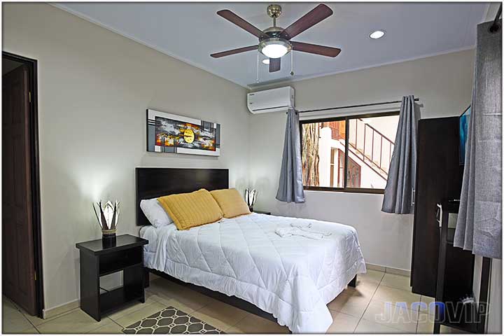 Bedroom with ceiling fan and air conditioning