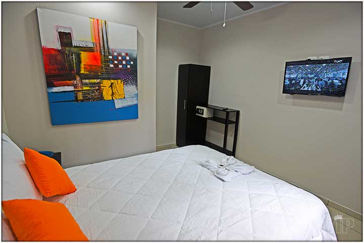 Queen size bed and wall mounted TV