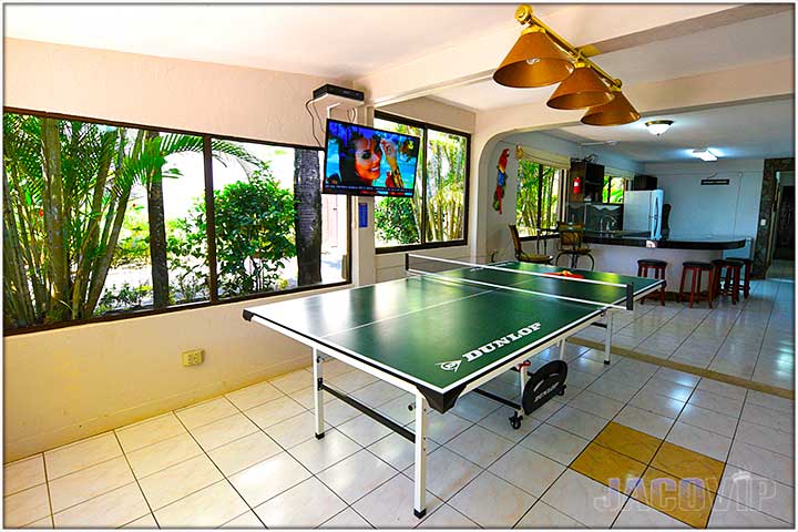 Ping pong table in room with lots of windows