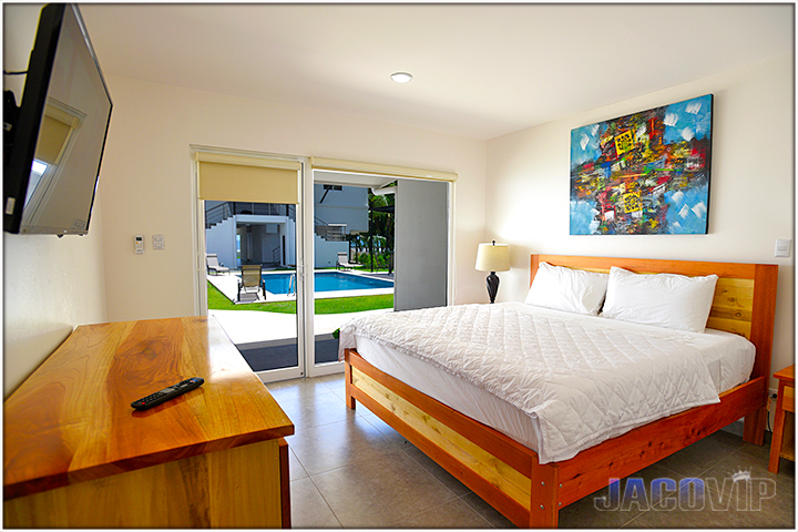bedroom number 12 with queen size bed and pool view