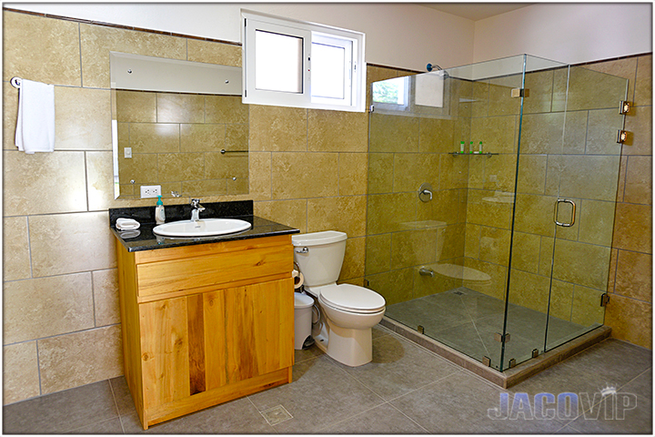 private bathroom with beige tile