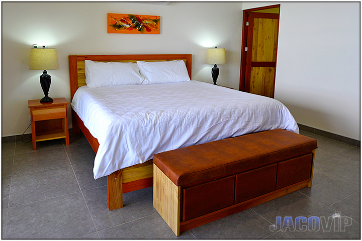 King size bed on wood bedframe and nightstands with lamps