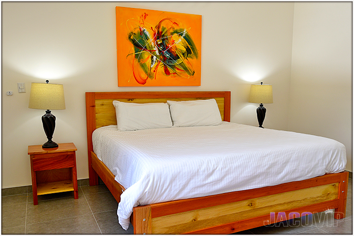 orange artwork above the bed