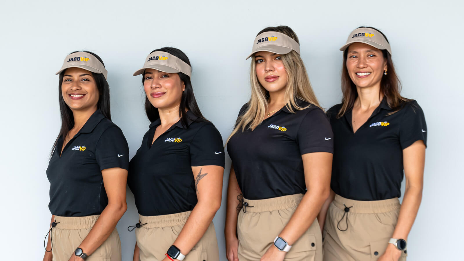 Group photo of JacoVIP concierge staff smiling outside the main office