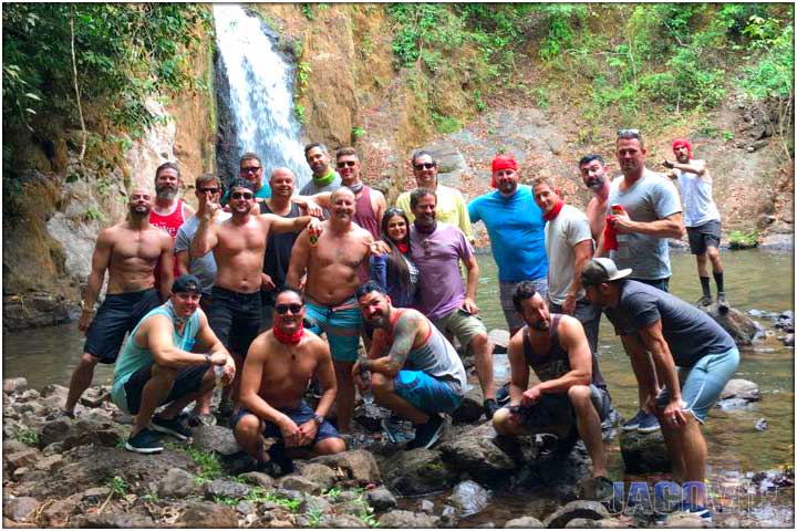 Bachelor party group ATV tour posing at Gamalotillo waterfall near Jaco in Costa Rica