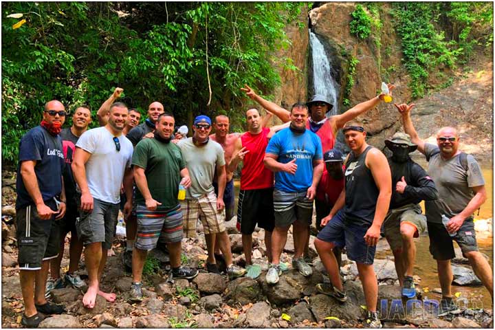 Large bachelor party group at waterfall