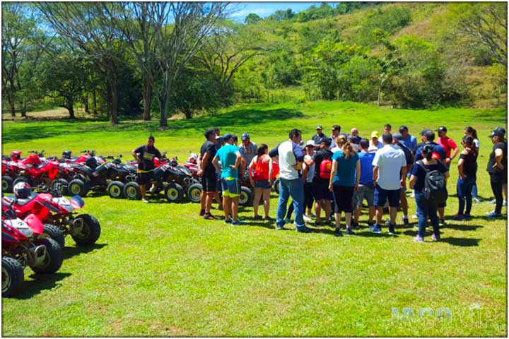 Large group of people on atv tour gathered on a field