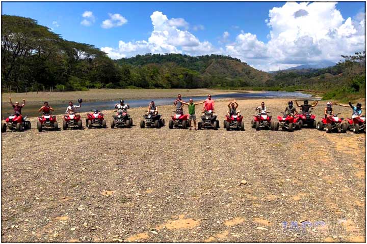Long line of atvs side by side and in front of river