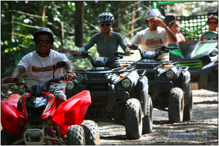 Four different types of ATVs driving down road in Costa Rica