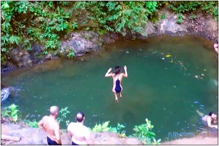Girl jumping into pond