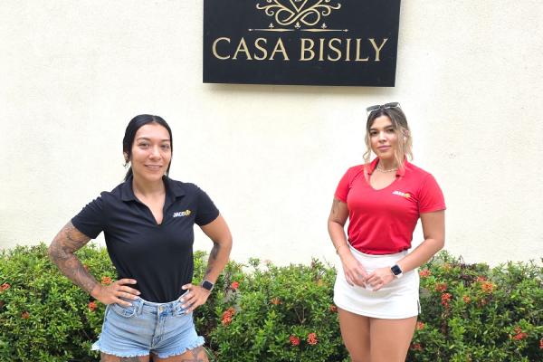 2 JacoVIP concierges in front of Casa Bisily sign in Playa Hermosa