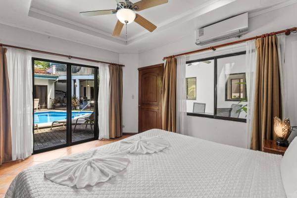 view of pool through patio window doors bedroom 2