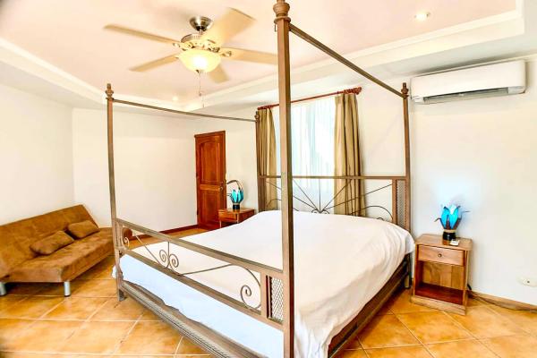 1 King Size Bed Bedroom 3 at Casa Cuatro Jaco with bronze four-poster king bed on second floor