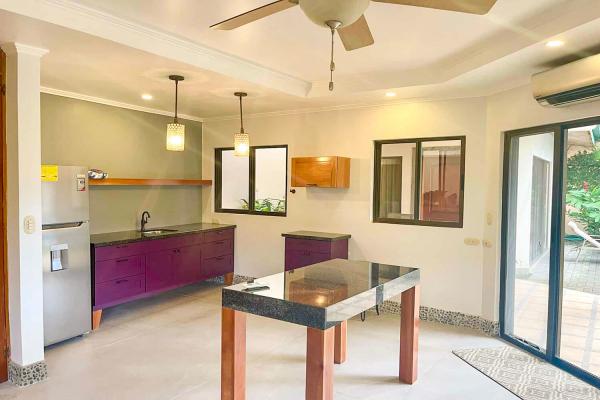 Secondary kitchen and living room at Casa Cuatro, simple layout with pool view