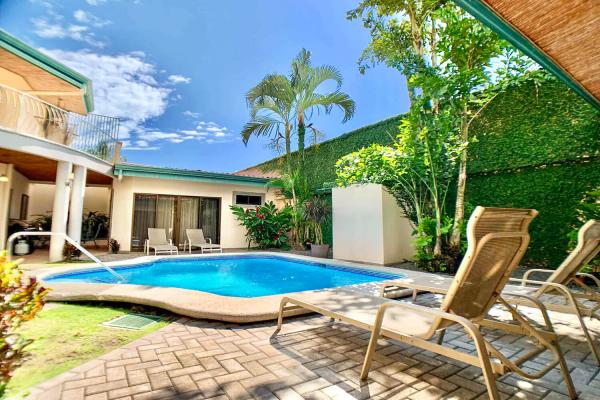 Lounge chairs and pool at Casa Cuatro vacation rental villa in Jaco
