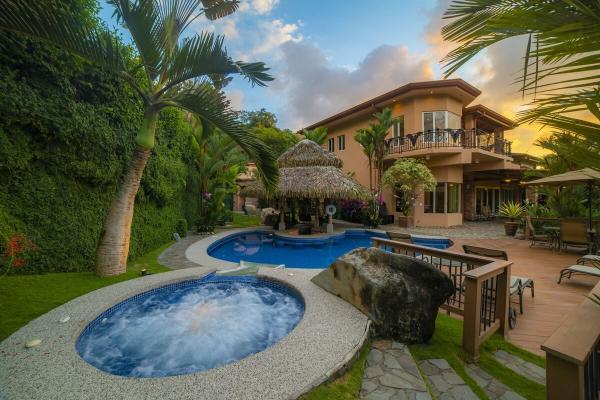 Back patio with pool and jacuzzi at Villa Oasis