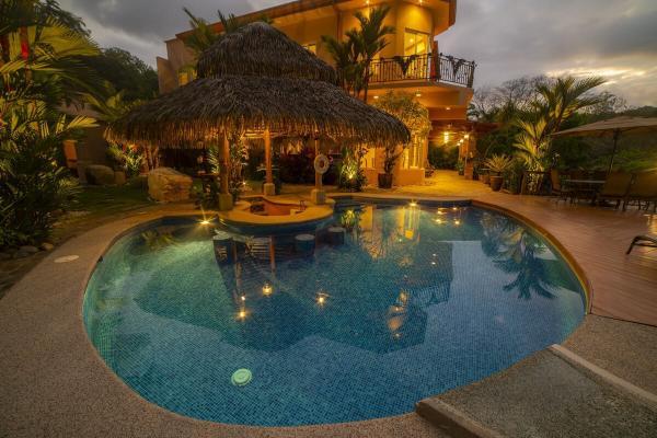 Pool and back facade at Oasis House 