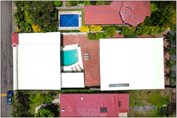 Directly overhead drone photo of Casa Toucan and white roof tops