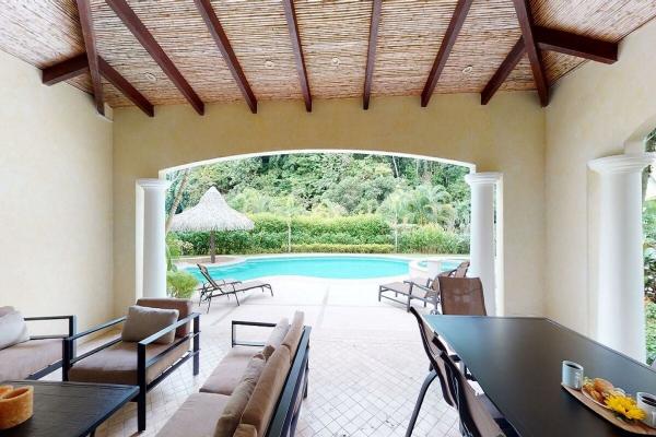 View of the outdoor living area and the pool in the back