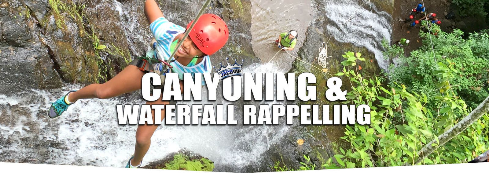 Girl rappelling down waterfall in Costa Rica