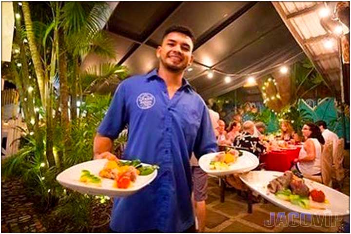Waiter with plates at Green Room restaurant in Jaco