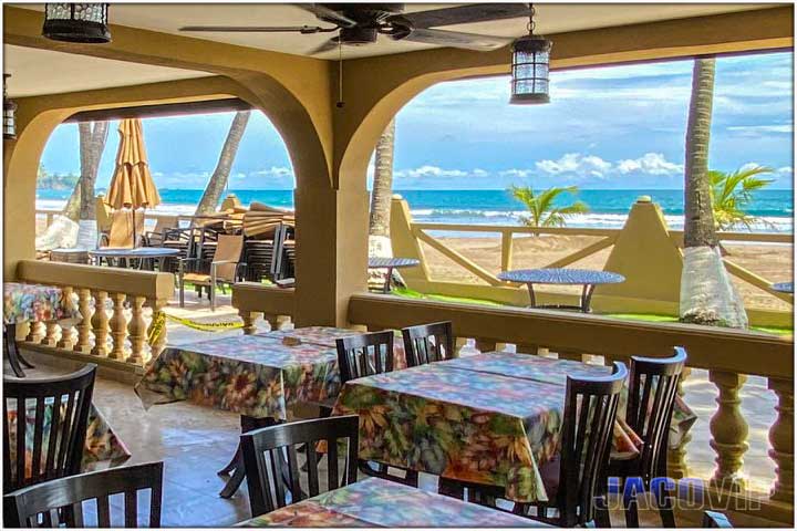 Hotel Cocal restaurant tables and Jaco beachfront view