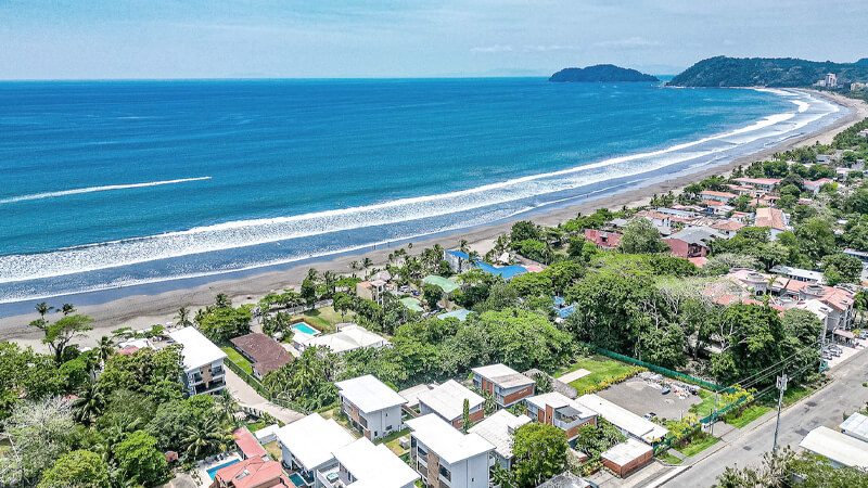 Aerial view of Jaco Beach coastline and town from above