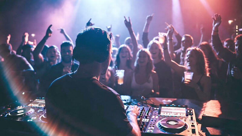 Vibrant Jaco Beach nightlife with bars and clubs lit up at night