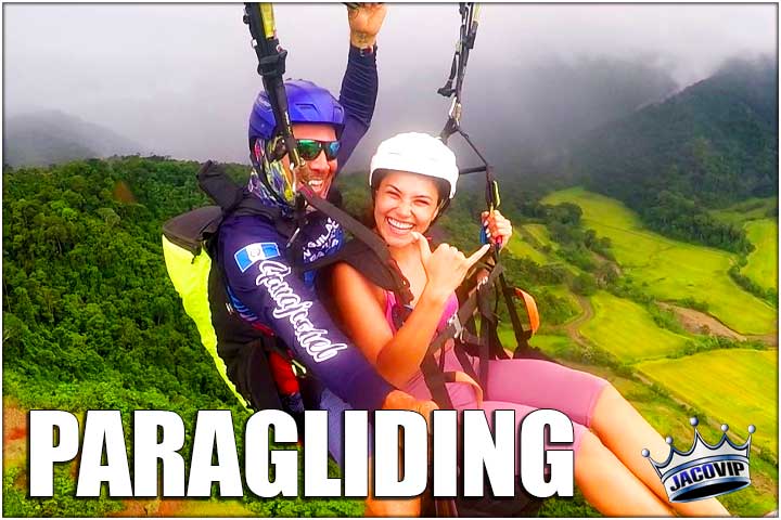 Girl paragliding in tandem with guide above Jaco Beach Costa Rica