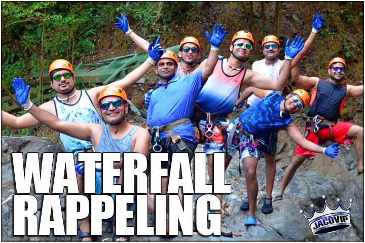 Group of guys on a waterfall rappeling tour near Jaco Beach in Costa Rica