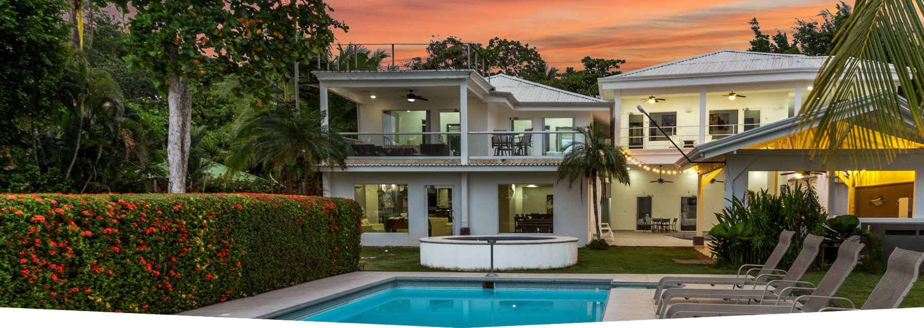 Twilight view of Casa Blanca with private pool and jacuzzi in Jaco Beach, Costa Rica.