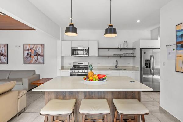 kitchen area and kitchen island with bar stools