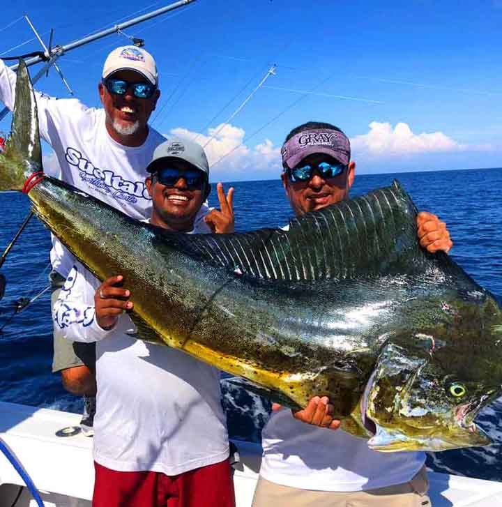 3 guys on sport fishing boat in costa rica with mahi mahi dorado