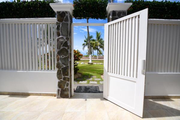 Open gate leading to Jaco Beach