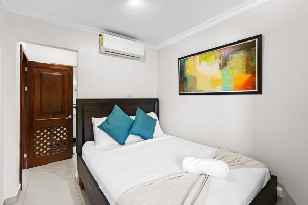 Bedroom seven on the third floor with queen bed and art